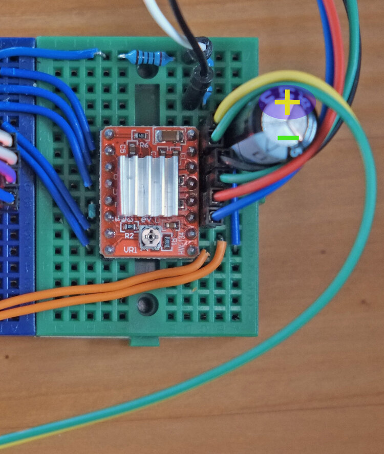 Figure 7: When connecting the 9V DC source it is important to match the positive side of the capacitor with the positive power source and negative side (marked in grey) with the ground of the power source. In the case you mismatch, the capacitor will make a small explosion and spew out gas.