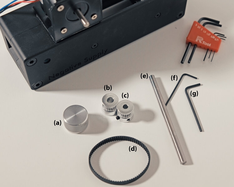 Figure3:  (a) is a negative supply knob to manually rotate the shaft, (b, item 22) is mounted on (e, item 6), and (c, item 6) is mounted on the stepper motor (item 1). (d, item 5) is a 158mm belt. Mounting (a),(b) and (c) are done using (f) and (g) are 1.27 and 1.5 hex key respectively (from item 10).