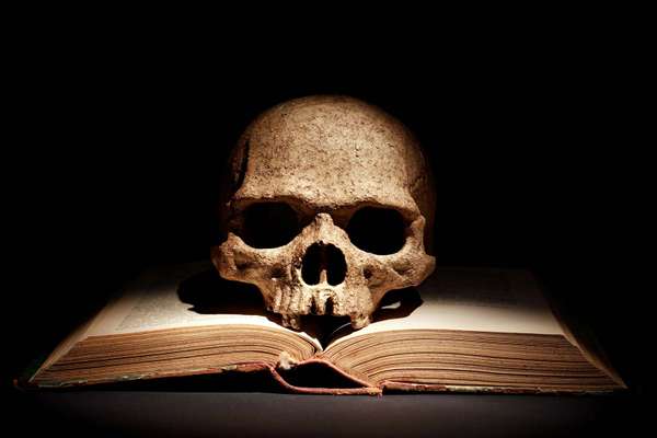 Human skull on open book. witchcraft, bone, eternity, sorcery, tragedy, Yorick, Hamlet, death, bad book list