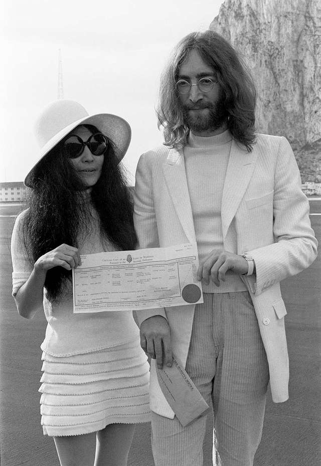 John Lennon and Yoko Ono holding their marriage certificate after their wedding in Gibraltar, March 20, 1969.