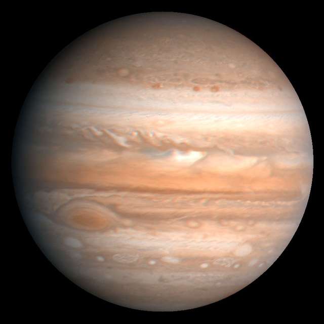 The fifth planet from the sun, Jupiter is one of the gaseous outer planets that lack a solid surface. The Great Red Spot, a storm system twice as wide as the Earth, is visible at lower left. This image is based on observations made by the Voyager 1 spacecraft in 1979.